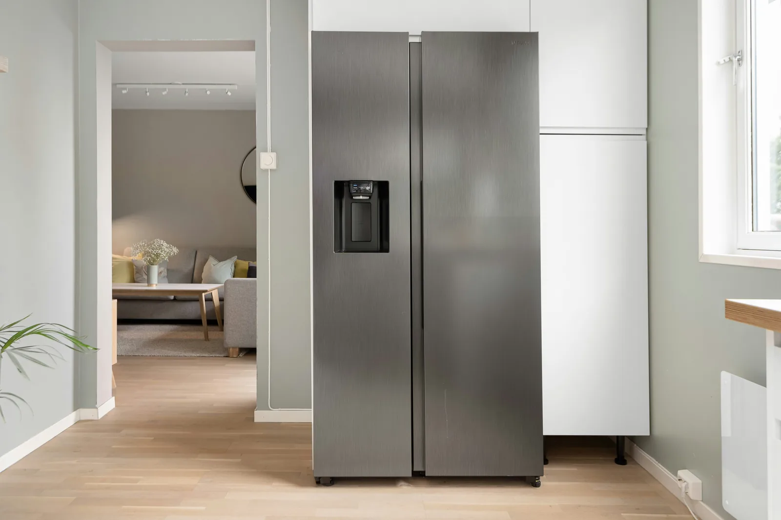 Stainless side-by-side refrigerator in a modern home kitchen