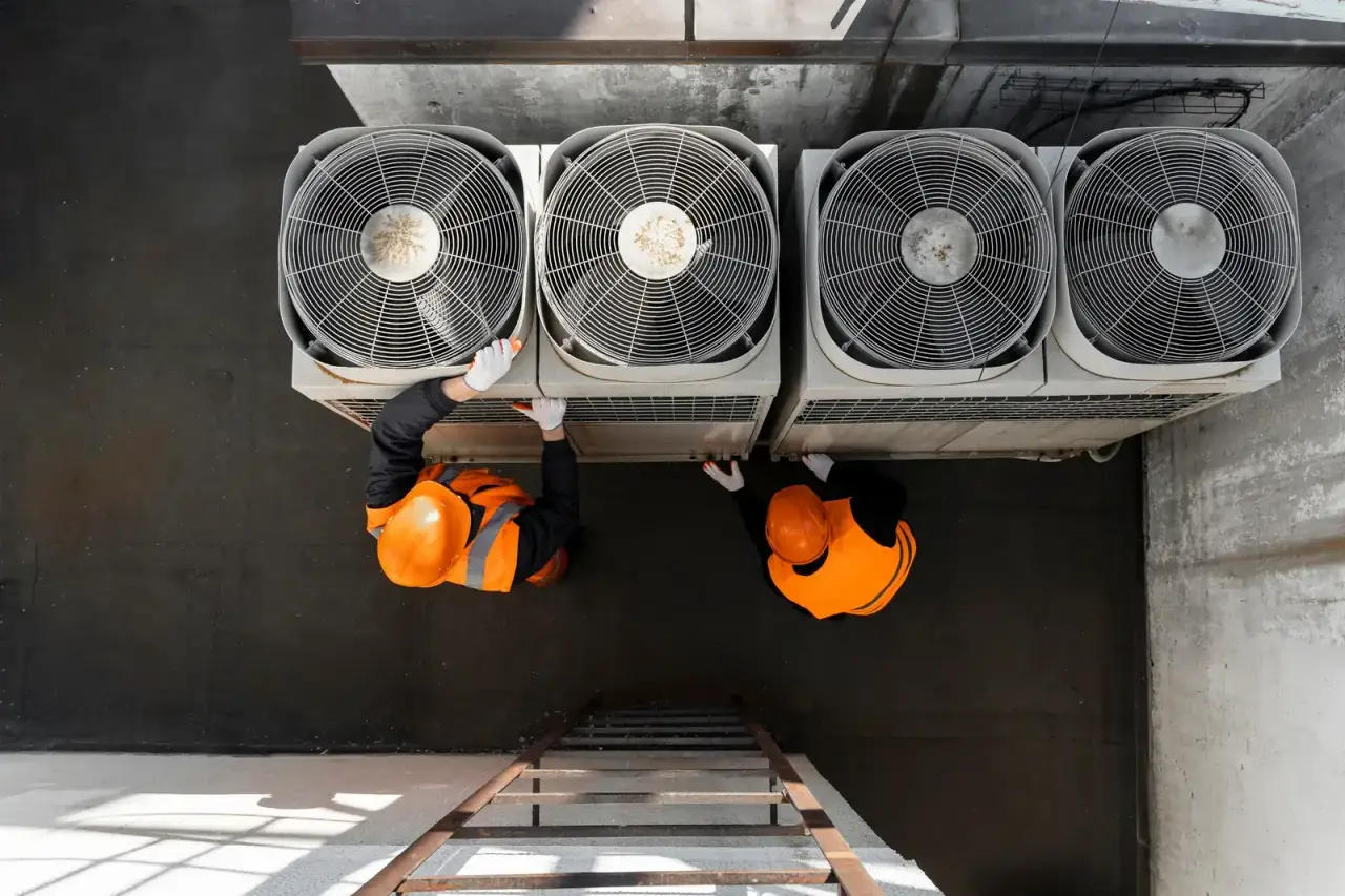 Technicians servicing rooftop condensing units